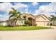 A landscaped front lawn wraps around this appealing house featuring a stone accent façade and a three-car garage at 2814 Sheldon St, Lakeland, FL 33813