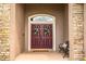 A welcoming covered entryway featuring a double front door with decorative wreaths, stone accents, and a bench at 2814 Sheldon St, Lakeland, FL 33813