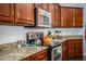 Gourmet kitchen features granite countertops, stainless steel appliances, and custom cabinetry for the cooking enthusiast at 2814 Sheldon St, Lakeland, FL 33813