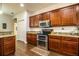 Modern kitchen featuring granite counters, stainless steel appliances, and rich wood cabinetry at 2814 Sheldon St, Lakeland, FL 33813
