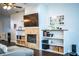 Cozy living room with a stone fireplace, built-in shelves, and a large screen television for relaxing entertainment at 2814 Sheldon St, Lakeland, FL 33813