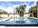 Beautiful pool area showcasing mosaic tile accents, landscaping and a slide for summer fun at 2814 Sheldon St, Lakeland, FL 33813