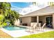 Backyard featuring a pool, patio area with an outdoor kitchen, and plenty of lush tropical landscaping at 2814 Sheldon St, Lakeland, FL 33813