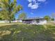 View of the backyard, showing a green lawn and partial view of the home at 2821 Grapefruit Dr, Auburndale, FL 33823