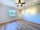 Bedroom with hardwood floors, ceiling fan and an abundance of natural light at 2821 Grapefruit Dr, Auburndale, FL 33823