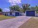 Exterior view of the home's driveway and multiple car garage at 2821 Grapefruit Dr, Auburndale, FL 33823