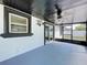 Enclosed patio with black trim windows and white walls, featuring a ceiling fan at 2821 Grapefruit Dr, Auburndale, FL 33823