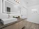 Modern bathroom featuring double sinks, sleek cabinetry, and an illuminated mirror at 300 Keswick Ave, Davenport, FL 33897
