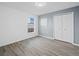 Comfortable bedroom with wood-look floors, double closet, and plenty of natural light at 300 Keswick Ave, Davenport, FL 33897