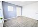 This bedroom features wood-look floors and a neutral paint palette, great closet space, and natural light at 300 Keswick Ave, Davenport, FL 33897