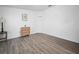 Spacious bedroom featuring wood-look flooring, ample natural light, and modern accents at 300 Keswick Ave, Davenport, FL 33897