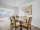 Dining room features a glass table, six chairs, and modern decor at 300 Keswick Ave, Davenport, FL 33897