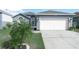 Charming single-Gathering home with a two-car garage and mature landscaping in a desirable neighborhood at 300 Keswick Ave, Davenport, FL 33897