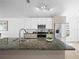 Stylish kitchen featuring granite countertops, stainless steel appliances, and a functional island at 300 Keswick Ave, Davenport, FL 33897