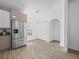 Bright kitchen features stainless steel appliances, modern cabinets and wood-look flooring at 300 Keswick Ave, Davenport, FL 33897