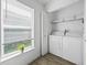 Convenient laundry area with a window, providing natural light and a view of the outdoors at 300 Keswick Ave, Davenport, FL 33897