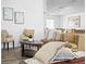 Living area featuring comfortable seating, artwork, and wood-look flooring at 300 Keswick Ave, Davenport, FL 33897