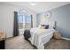 Bright main bedroom with a large window, wood-look floors, and stylish decor at 300 Keswick Ave, Davenport, FL 33897