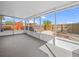 Enclosed lanai overlooking a backyard featuring mature landscaping, a wooden deck, and a hot tub at 300 Keswick Ave, Davenport, FL 33897