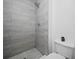 Tiled shower with a modern showerhead and complementary tile flooring at 300 Keswick Ave, Davenport, FL 33897