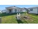 Large backyard with a swing set, privacy fence, and plenty of green space at 301 St Georges Cir, Eagle Lake, FL 33839