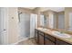 Bathroom featuring a double vanity and a walk-in shower at 301 St Georges Cir, Eagle Lake, FL 33839