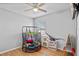 Bedroom featuring a small play area with hardwood floors and a ceiling fan at 301 St Georges Cir, Eagle Lake, FL 33839