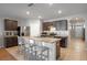 Bright kitchen with a large island, stainless steel appliances, tile backsplash, and tile flooring at 301 St Georges Cir, Eagle Lake, FL 33839