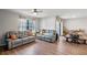 Inviting living room featuring hardwood floors, neutral paint, two couches, and lots of natural light at 301 St Georges Cir, Eagle Lake, FL 33839