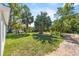 The lawn features lush grass and mature trees at 302 Ave P Nw, Winter Haven, FL 33881