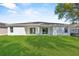 The backyard boasts a green lawn and a white-painted exterior at 302 Ave P Nw, Winter Haven, FL 33881