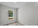 An empty bedroom with wood-look flooring and a window at 302 Ave P Nw, Winter Haven, FL 33881