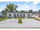 Charming duplex featuring a well-maintained lawn and spacious concrete driveway at 302 Ave P Nw, Winter Haven, FL 33881