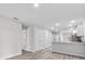 Open kitchen and entry area with sleek laminate floors and ample storage at 302 Ave P Nw, Winter Haven, FL 33881