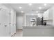 A view of an open kitchen with white cabinets and granite countertops at 302 Ave P Nw, Winter Haven, FL 33881