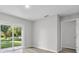 Bright living room featuring wood-look flooring and sliding doors to the backyard at 302 Ave P Nw, Winter Haven, FL 33881