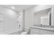 Bathroom with a white vanity with a granite top, a tub with shower, and a toilet at 304 Ave P Nw, Winter Haven, FL 33881
