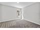 Neutral bedroom featuring carpeted floor and view to the outside at 304 Ave P Nw, Winter Haven, FL 33881