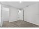 A carpeted bedroom featuring an access to a walk-in closet at 304 Ave P Nw, Winter Haven, FL 33881