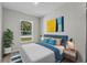 Bedroom with a blue headboard and bright natural light at 304 Ave P Nw, Winter Haven, FL 33881