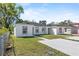 Charming single-story home with a well-maintained lawn and neutral-colored exterior at 304 Ave P Nw, Winter Haven, FL 33881