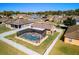 An aerial shot showcases a backyard pool with a screened enclosure in a residential neighborhood at 3137 Winchester Estates Loop, Lakeland, FL 33810