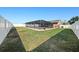 A wide shot of a fenced in backyard with a screened in pool at 3137 Winchester Estates Loop, Lakeland, FL 33810