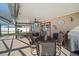 The covered patio features comfortable seating, a ceiling fan, and a mounted TV at 3137 Winchester Estates Loop, Lakeland, FL 33810