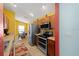 Modern kitchen with stainless steel appliances, wooden cabinetry, and a dining area nearby at 3137 Winchester Estates Loop, Lakeland, FL 33810