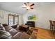 Bright living room with wood floors, vaulted ceilings, and a view of the screened pool at 3137 Winchester Estates Loop, Lakeland, FL 33810