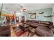 Inviting living room with hardwood floors, a leather sofa, and a view into the adjacent kitchen at 3137 Winchester Estates Loop, Lakeland, FL 33810