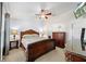 Spacious main bedroom features a ceiling fan and classic wooden furniture at 3137 Winchester Estates Loop, Lakeland, FL 33810