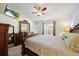 Comfortable main bedroom with large dresser, big mirror, and a ceiling fan at 3137 Winchester Estates Loop, Lakeland, FL 33810