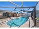 A screened pool with blue tile provides a refreshing outdoor oasis at 3137 Winchester Estates Loop, Lakeland, FL 33810